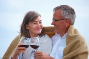 Portrait of a romantic old couple toasting wineglasses